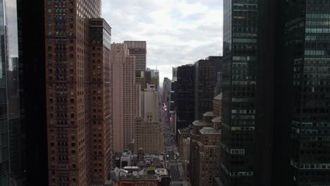 aerial view over the 7th avenue, in manhattan, new york city, usa - reverse, drone shot