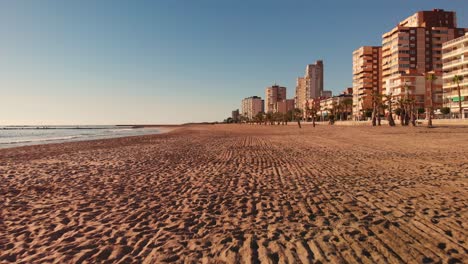 sunny but empty beach in el campello, costa blanca, spain