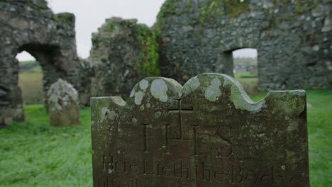 ruin of an old stone church with graves ireland