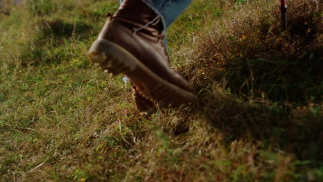 closeup man legs climb mountains hill. tourist hike in trekking boots outside.