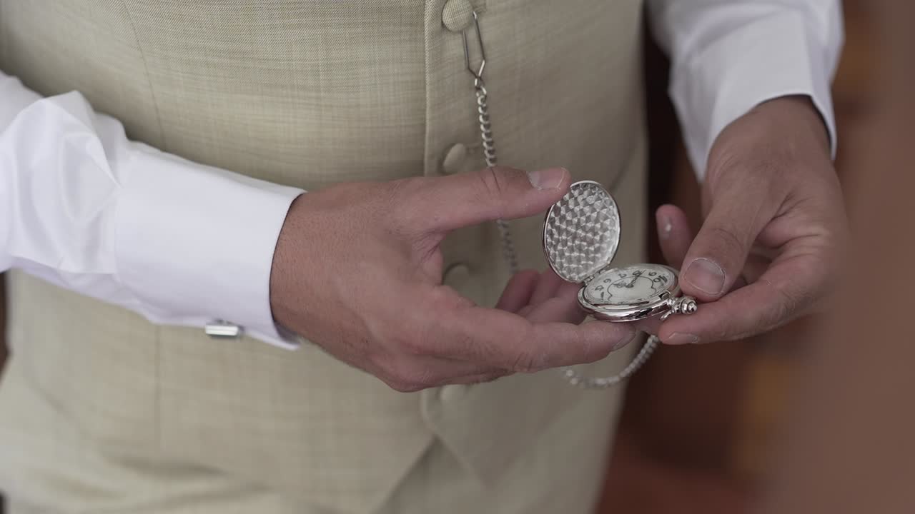 Elegant hand holding a vintage pocket watch, symbolizing time and tradition