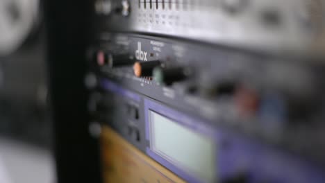 close up of audio recording device with knobs and switches