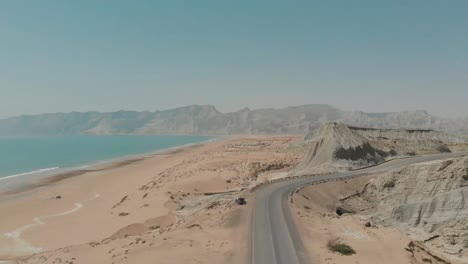 aerial view of winding makran coastal highway in balochistan. pedestal up
