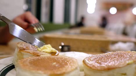 buttering-on-a-Fluffy-Pancakes-[side-angle-close-up