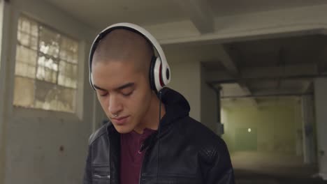 fashionable young man in an abandoned warehouse