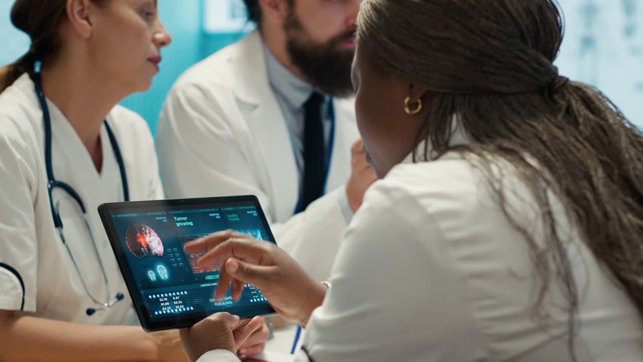 Doctors discussing x-ray on tablet