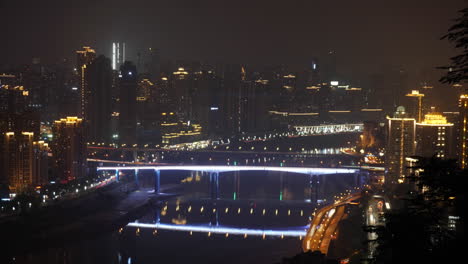 night view of a city with a bridge and river