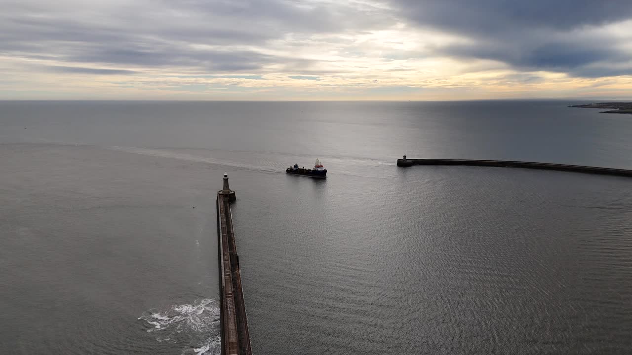 Drone aerial view cargo oil ship tanker pulling into harbour port north east england north shields uk trade global economy shipping