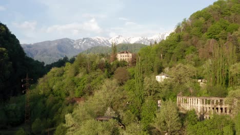 abandoned buildings in picturesque mountainous area covered with greenery