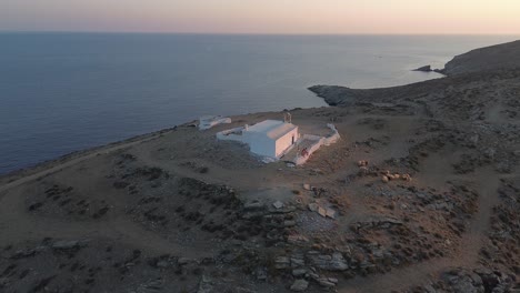 One-remote-building-complex-standing-on-hill-top-in-Greece,-Kythnos-Island,-aerial-orbit-shot