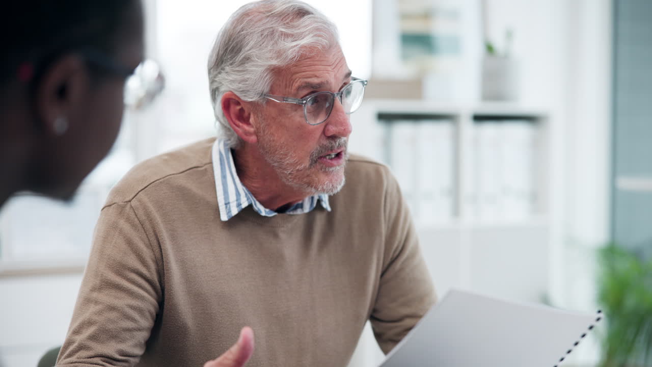 Business meeting with diverse colleagues discussing paperwork