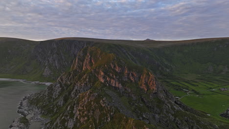 stave norway aerial v12 norwegian scenic view, flyover coastal mountainside capturing details of rocky mountain ridges, panning reveals beautiful golden sunset - shot with mavic 3 cine - june 2022