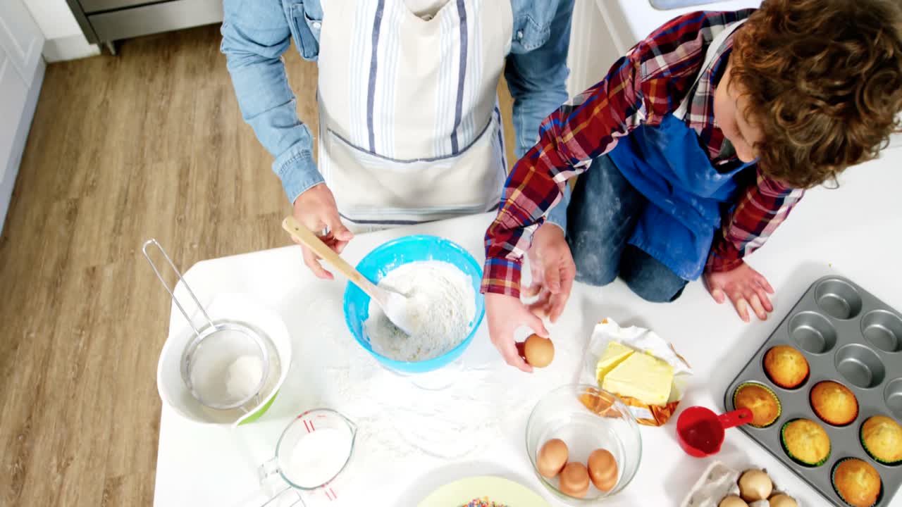 Father and son preparing cupcake