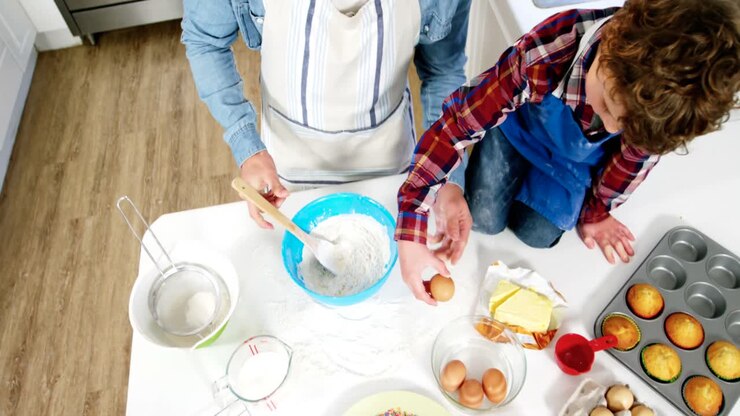Father and son preparing cupcake
