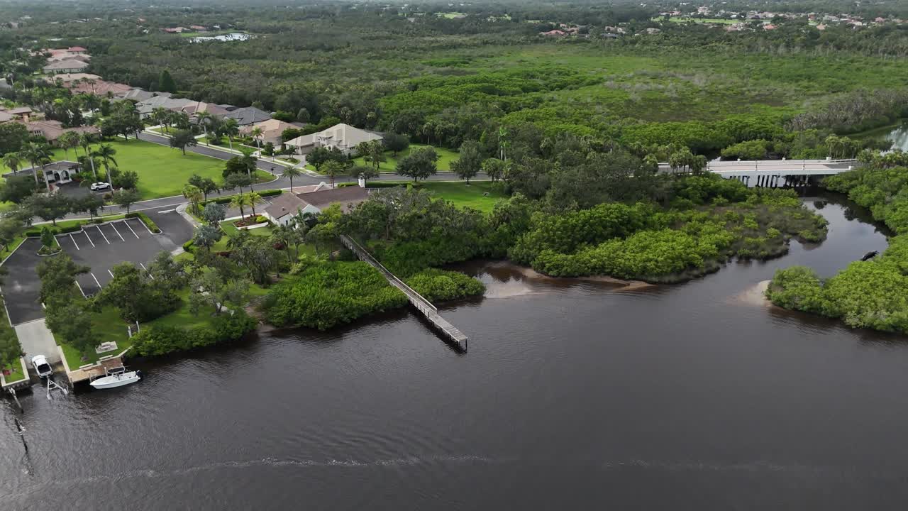 aerial turn to reveal luxury boating community homes off the Manatee River in Parrish, Florida