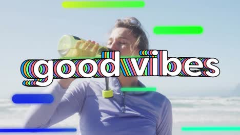 Animation-of-white-text,-good-vibes,-with-colourful-shapes,-over-woman-drinking-water-on-beach