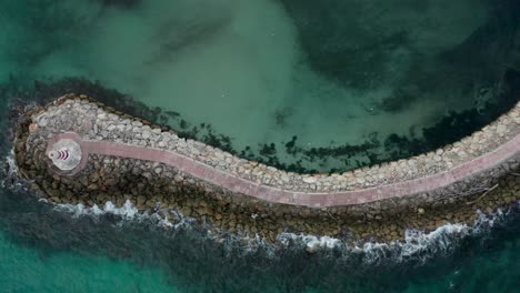 awesome drone shot revealing how the waves dance in time with the rocks of this heavenly place