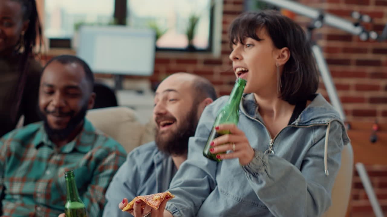 Diverse friends making toast with beer bottles and watching movie