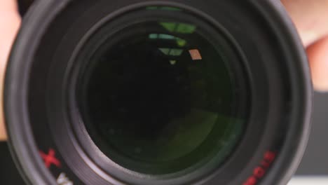 camera zoom. closeup shot of professional video camera, with its lens zooming in and out