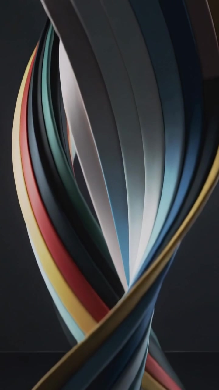 Vertical video: Pulling back camera, ribbon helix rotating and revealing color faces in dark studio