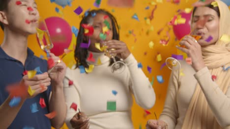 Studio-Shot-Of-Multi-Cultural-Group-Celebrating-At-Party-With-Balloons-Making-A-Toast