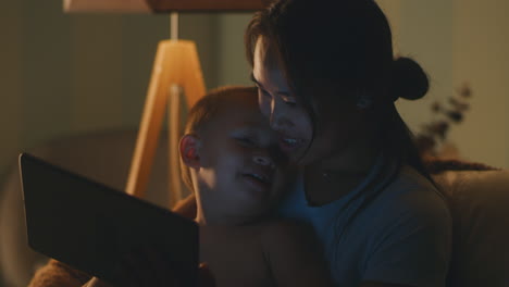 mother and child enjoying story time on tablet