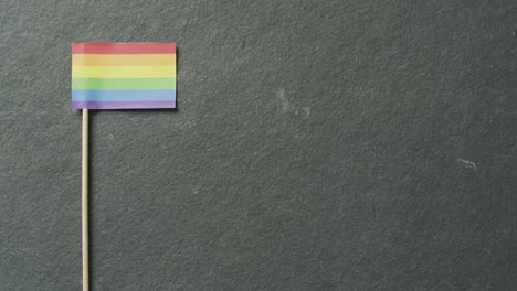 video of rainbow flag lying on white background