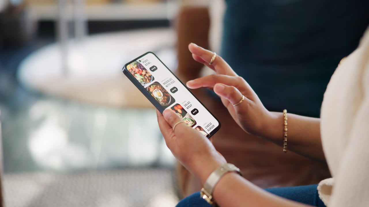 Person's Hands Scrolling Through Food Delivery App on Smartphone
