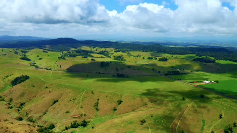 lush green hills and meadow at daytime in countryside area of atherton in tablelands, qld, australia