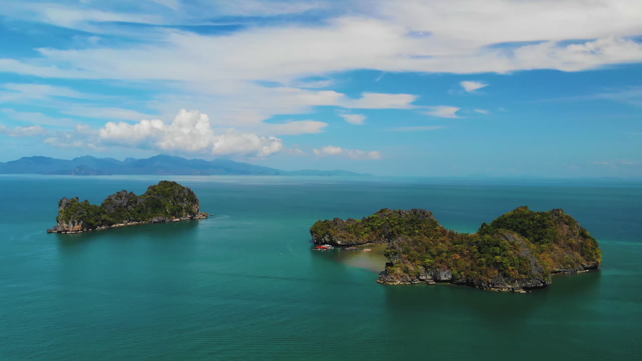 Close aerial footage of Pulau Gasing and Pulau Pasir, near the Langkawi Island of Malaysia