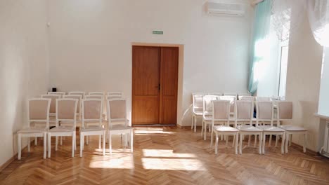 cozy room with empty chairs and sunlight from the windows