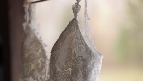 close up of a elegant wedding dress hanging outside on a fall day as bride prep for a wedding ceremony