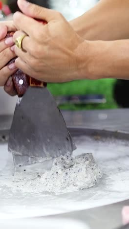 crafting rolled ice cream at a bustling market
