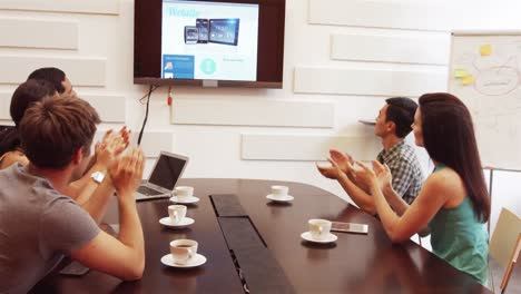 Business-executive-applauding-during-a-video-conference
