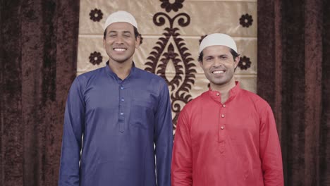 two muslim men smiling to the camera