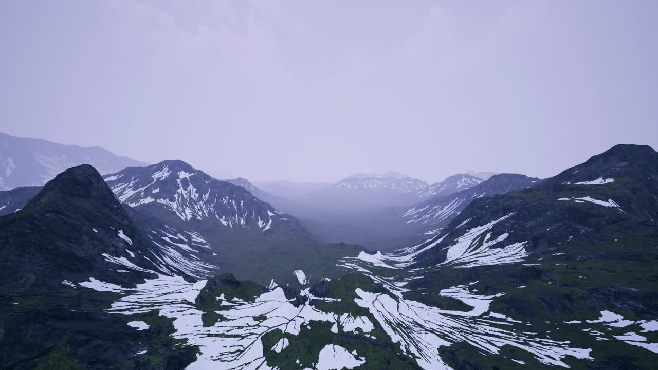 Majestic mountain landscape with snow and green valleys during twilight
