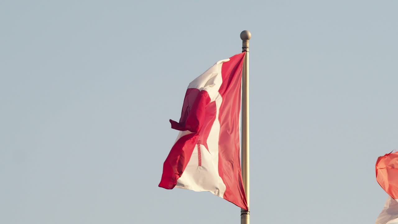 Canadian flag. Canada symbol. National patriotism, travel destinations, tourism. America. Moved by the wind in a flag pole.