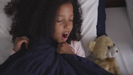 african american girl sleeping and yawning in her bed