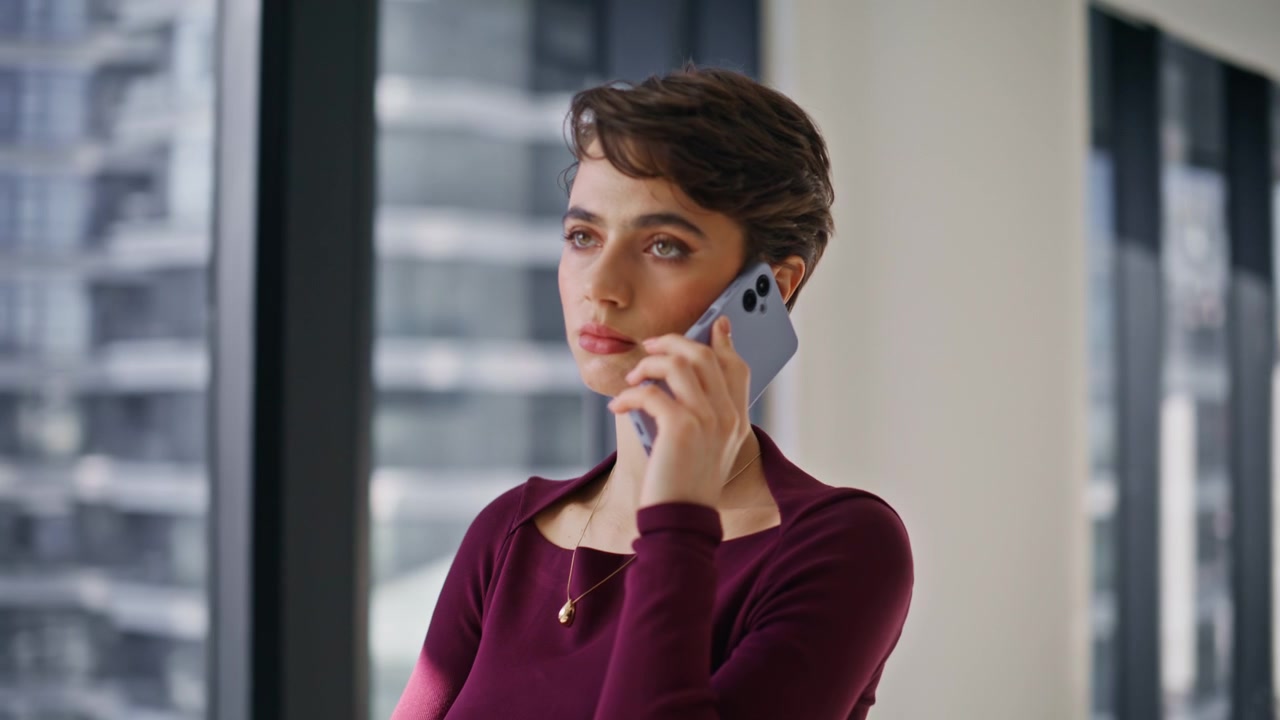 Pensive business lady talking mobile phone office. Closeup woman calling window
