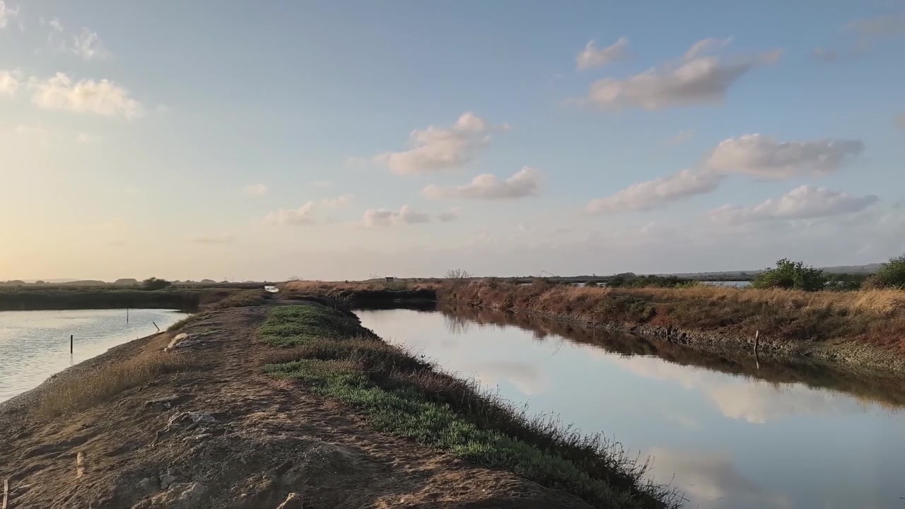 Paisaje sereno de salinas al atardecer.