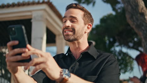 happy guy talking phone camera on city street close up. cheerful man video call