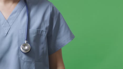 close up of male doctor with stethoscope on green screen background in the hospital