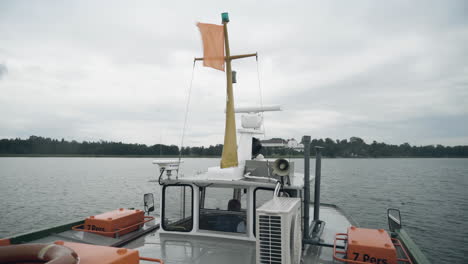 smooth shot of transport ship cruising on the lakechiemsee in germany towards the famous herreninselduring a cloudy day in the morning