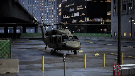 military helicopter in city parking lot at night