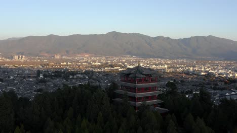 Lijiang-city-in-Yunnan-province-China,-Jade-Dragon-Mountain-backdrop,-aerial