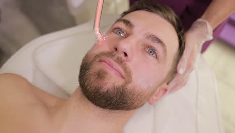 man receiving facial treatment