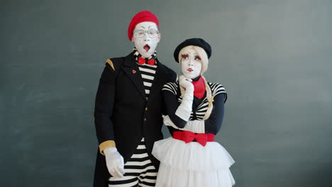 mime couple posing in front of chalkboard