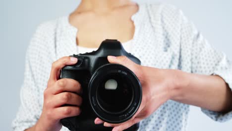 photographer adjusting camera lens