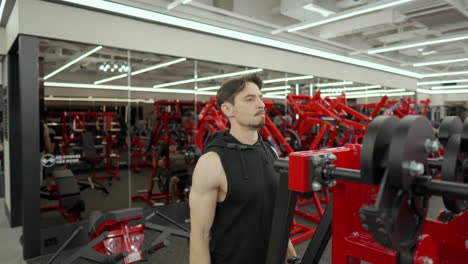 sporty man train shoulders in gym