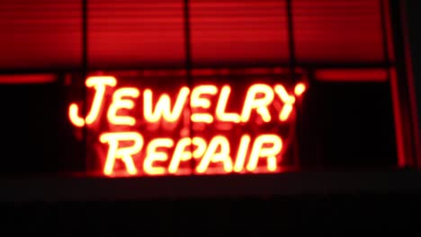 neon-jewelry-repair-sign-in-out-of-focus